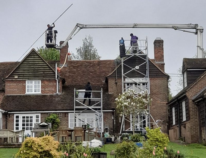 The Roof Moss Cleaners using cherry picker and scaffolding to clean roof safely and professionally in Corby, Northamptonshire