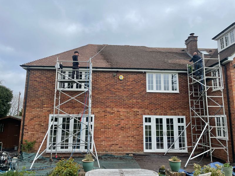 Roof cleaning carried out safely from scaffold towers by The Roof Moss Cleaners in Corby